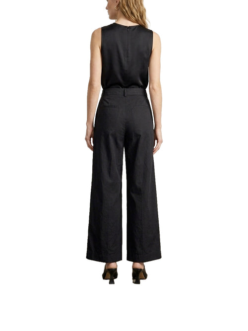 Pantalone asimmetrico con bottone